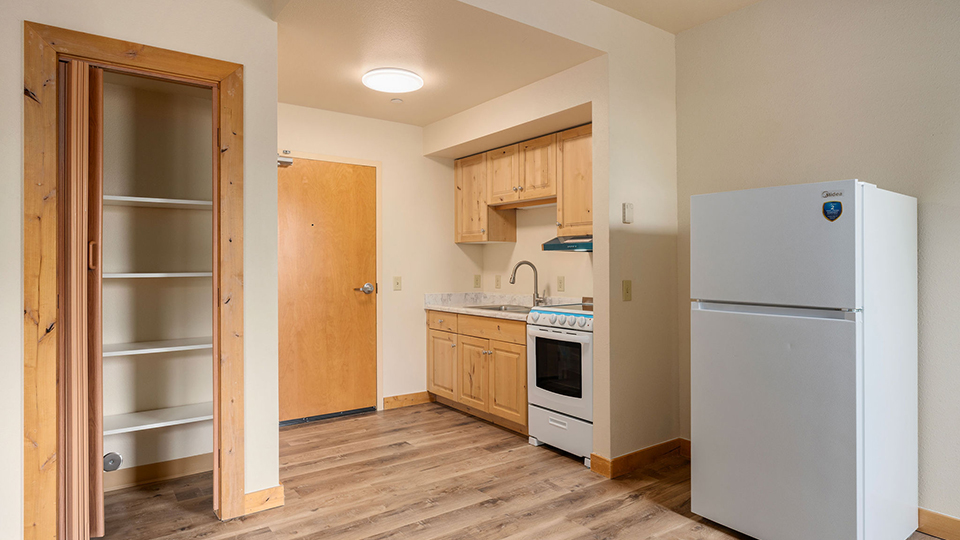 Updated Legacy Lodge full kitchen with range, oven, refrigerator, sink, cabinets and counter space