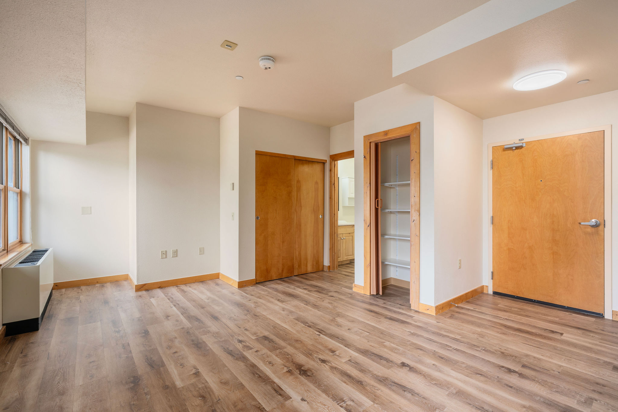 Actual updated Legacy Lodge living area with wood-style floors, closets and storage